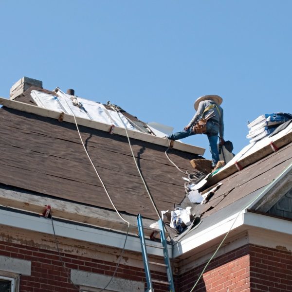 roofer working of historic house